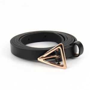 Detail of a thin black leather belt featuring a sleek golden triangular metal pin buckle
