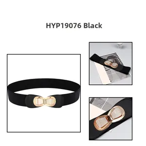 Close-up of black elastic waist belt featuring a gold butterfly buckle with inlaid rhinestones