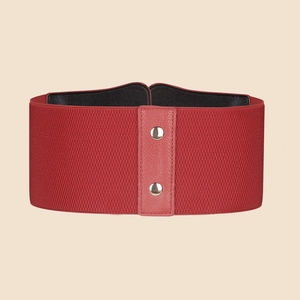 Detail view of the red elastic waist belt with faux leather panel and silver snap buttons