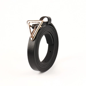Detail of black leather belt for women with a gold triangular metal buckle and pin closure