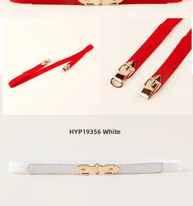 Detail view of red and white thin elastic belts featuring polished gold geometric metal buckles