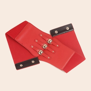 Detail of red elastic waist belt featuring golden metallic round buckles and leather accents