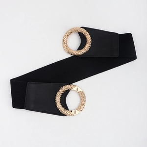Detail of black elastic belt featuring textured gold circular interlocking buckles and leather