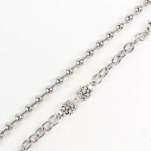 Close-up of retro silver dual-layer hip hop chain with detailed metal skull charms