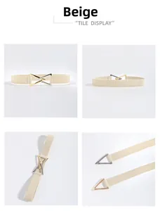 Dettaglio di una cintura elastica beige con fibbia a triangolo intrecciata oro e argento