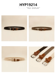 Detail view of woven stretch belts with polished metal buckles and leather reinforcement
