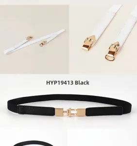 Detail view of thin elastic waist belts in black and white with gold metal buckles