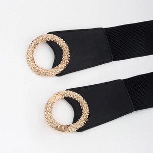 Women black wide elastic waist belt with textured gold circular buckle in minimalist style