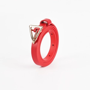 Detail view of red leather belt with elegant golden triangle buckle on white background