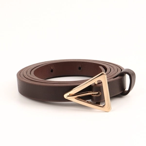 Close-up of a slim dark brown leather belt with a minimalist golden triangular buckle