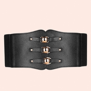 Detail of black elastic wide waist belt featuring vintage gold round metal buckles