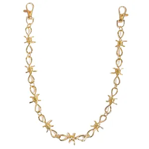 Golden barbed wire pant chain with metal lobster clasps on a white background