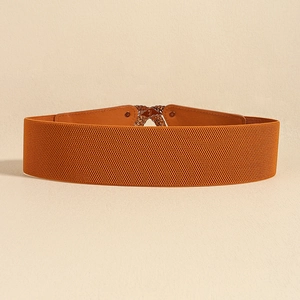 Detail view of orange elastic corset belt featuring gold metal buckle and leather trim