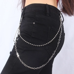 Double-layered silver metal pant chain with skull charms and safety pin on black jeans