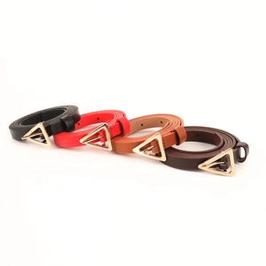 Detail view of thin leather belts for women with modern gold triangle buckles in four colors