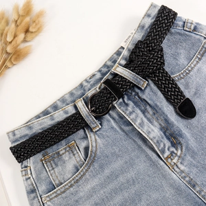 Black braided elastic belt with round metal buckle shown on denim jeans for casual wear