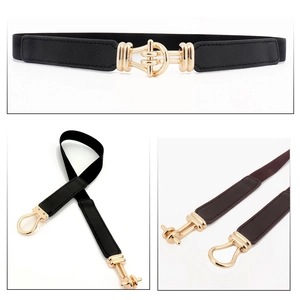 Detail of elastic waist belt with gold horsebit buckle in black and brown colors