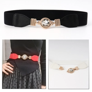 Detail of elastic waist belts in black, red, and white with gold crystal buckles