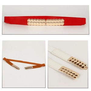 Detailed close-up of elastic waist belts with golden scale-shaped metal buckle design