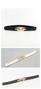Close-up of elastic thin waist belts featuring elegant golden leaf metal buckles in three colors