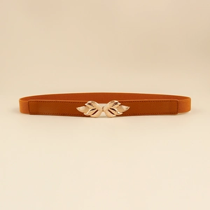 Detail view of brown elastic waist belt featuring a gold wing-shaped metal buckle