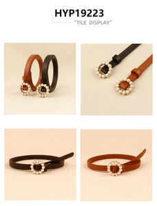 Detailed view of women's skinny belts with gold pearl buckles in black and brown