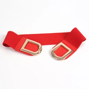 Detail of red elastic waist belt with double D-shaped golden metal buckles and leather trim