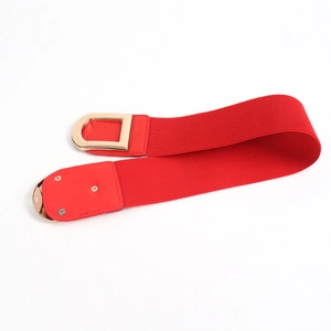 Detailed view of bright red elastic waist belt with golden D-ring metal buckle