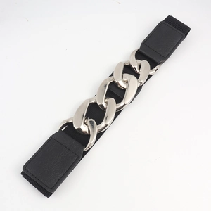 Dettaglio della cintura elastica nera con catena decorativa in metallo argento lucido