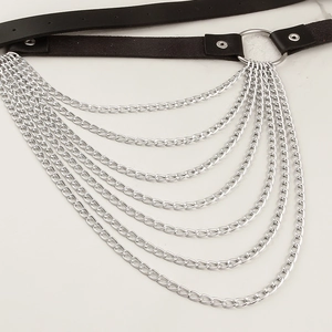Detail view of multilayer metal chains and O-ring connector on black leather punk belt