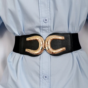 Close-up of black elastic waist belt with large golden metal buckle on a blue shirt