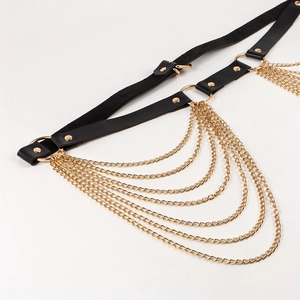 Macro shot of layered gold chains and black leather belt with metal square buckles
