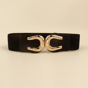 Detail of elastic black waist belt featuring a textured interlocking gold double ring buckle