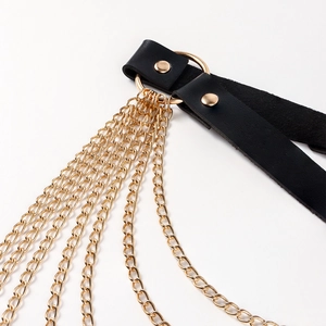 Detailed close-up of punk style black leather belt with tiered gold chain fringe details