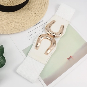 Detail of white elastic wide waist belt for women with golden double U buckle design