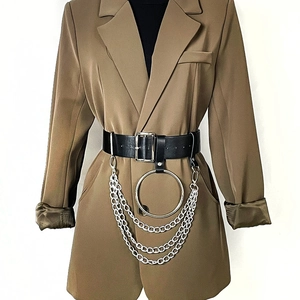 Detail of a punk style wide belt with silver metal chain layers and large hoop rings