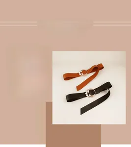Close-up of elegant wide belts with pearl-decorated gold buckles in black and brown