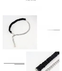 Detail of elastic PU belt with chunky silver chain and metal padlock pendant detail