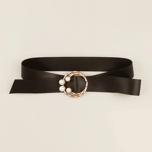 Close-up of elegant black belt featuring gold buckle and four white pearl accents