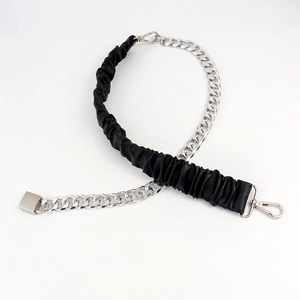 Close-up of silver Cuban chain with black pleated leather and metal swivel hooks