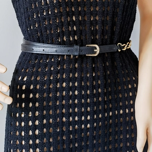 Detail eines schwarzen PU-Ledergürtels mit goldener Metallkette und D-Ring-Schnalle für Damen