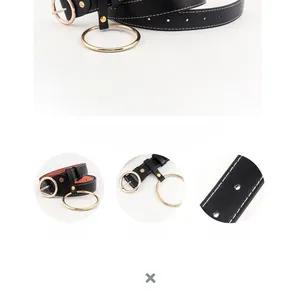 Détail de la ceinture en cuir noir avec boucle ronde dorée et surpiqûres blanches