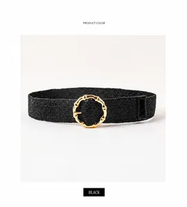Detail of black woven elastic belt with golden bamboo texture metal buckle for dresses