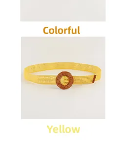 Detail of woven yellow straw belt featuring a dark brown round vintage buckle