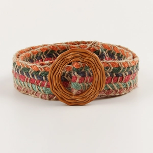 Detail of bohemian colorful woven belt with textured wooden buckle and fiber textures