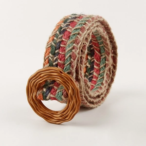 Macro detail of colorful woven straw belt with a vintage textured round buckle