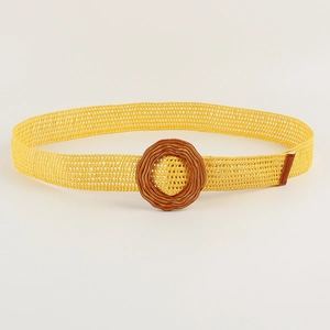 Detail of summer woven ginger yellow belt with a textured brown round buckle head