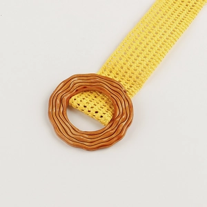 Bright yellow woven waist belt with a round wood-texture buckle for summer outfits