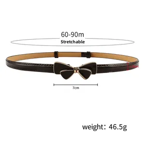 Black skinny belt with gold bow buckle and stretchable strap for adjustable waist size