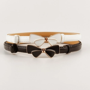 Detail of slim black and white leather belts featuring gold-tone butterfly buckles